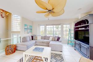 a living room with a couch and a ceiling fan at Dixie Beach Delight in Sanibel