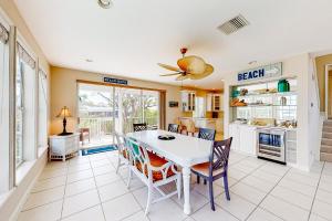a kitchen and dining room with a table and chairs at Dixie Beach Delight in Sanibel
