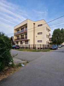 a large building with cars parked in front of it at Black Sea in Costinesti