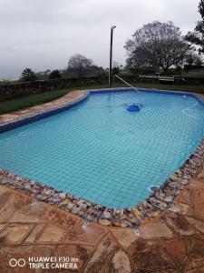 a large swimming pool with blue water at Crest Farm Communal Rooms in Waterfall