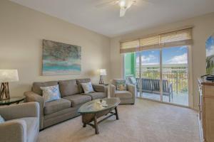 a living room with a couch and a table at Navy Cove Harbor 1205 by Vacation Homes Collection in Fort Morgan