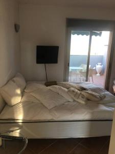 a bed in a bedroom with a view of the ocean at Experience beautiful duplex penthouse with terrace in Palma in Palma de Mallorca