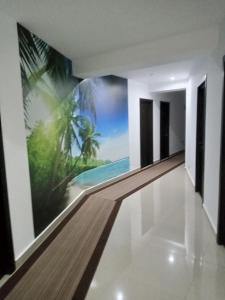 a hallway with a mural of a beach and palm trees at Black Sea in Costinesti