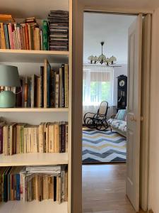 a room with a book shelf filled with books at Sopot Green 65 in Sopot