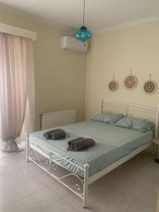 a bedroom with a bed with two bags on it at Apartment Aura in Argostoli
