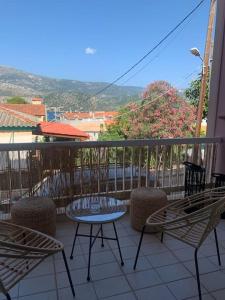 a balcony with chairs and a table on a balcony at Apartment Aura in Argostoli