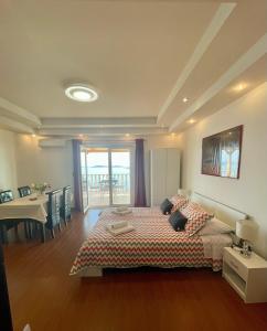 a bedroom with a bed and a table and a dining room at Apartments Marnic in Mlini