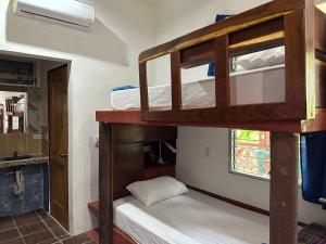 two bunk beds in a room with a window at Out Back Zapote in Flores