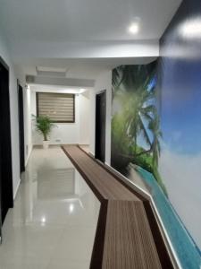 a hallway with a wall mural of a palm tree at Black Sea in Costinesti
