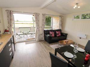 a living room with a couch and a table at Cotswold View 4 in Evesham