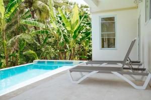 a chair sitting next to a swimming pool at Blissful Tides in Hope Bay
