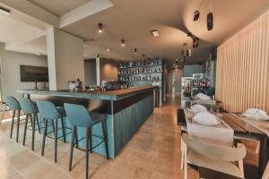 a bar in a restaurant with blue bar stools at Boutique Hotel Shell in Budva