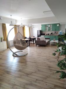 a living room with a hammock in the middle of the room at Leo in Atyraū