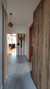 a hallway with a large wooden door in a house at Bohemian Home in Skopje