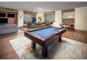 a living room with a pool table in it at The Amir Poolside View - Luxe Pool, Jacuzzi & Gym in Houston