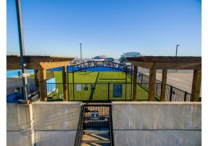 a batting cage in a park with a playground at The Amir Poolside View - Luxe Pool, Jacuzzi & Gym in Houston