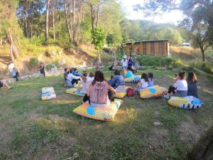 Un groupe de personnes assises sur des cylindres gonflables dans l'herbe dans l'établissement Sultaniye Camping, à Muğla