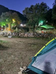 a tent sitting in a field at night at Sultaniye Camping in Mugla