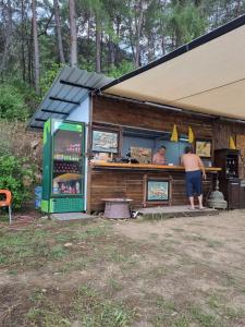a man standing at the counter of a food truck at Sultaniye Camping in Mugla