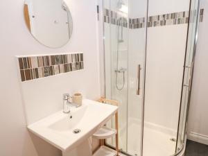a bathroom with a sink and a shower at Sandbanks in Penzance