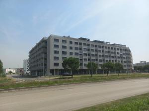 a large white building on the side of a road at Koper's door Apartment in Koper