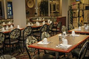a row of tables and chairs in a restaurant at Continental Inn & Suites in Edmonton