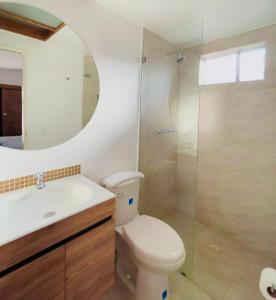 a bathroom with a toilet and a sink and a shower at Casa ALOHA 152 in Bogotá