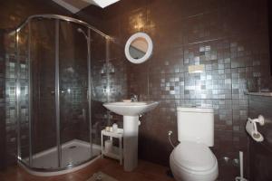 a bathroom with a shower and a toilet and a sink at Casa Pontenova in Cee