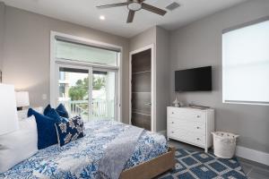 a bedroom with a bed and a tv and a window at Beautiful New Build - 450 Palermo home in Fort Myers Beach