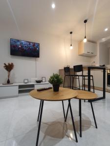 a living room with a table and a kitchen at Vacation Liberation Apartment in Split +27 photos