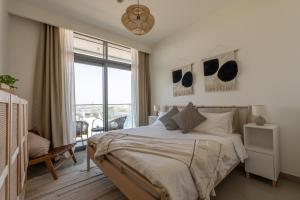 a bedroom with a bed and a large window at Luxury Penthouse I 220 deg View of the Palm I Dubai Harbour I Private Beach in Dubai