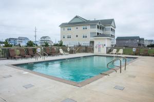 a swimming pool in front of a house at RSR2A - Endless Sunsets in Rodanthe