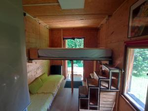 a tiny house with a couch and a bunk bed at Tiny House Lapradelle-Puilaurens in Puilaurens