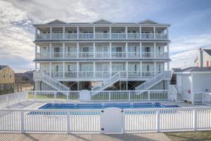 a large white house with a pool in front of it at SC304 - Top of the Banx in Kill Devil Hills