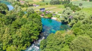 an aerial view of a river with blue water at Villa UNA LUX in Bihać