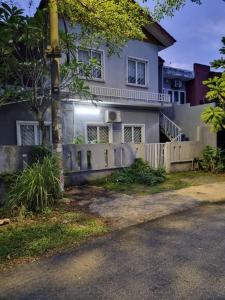 a house with a fence in front of it at Homestay GG Greenwood Gombak in Batu Caves