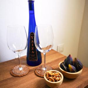 a table with two wine glasses and a bottle of wine at Apartamentos Mares de Lava - Playa Blanca in Playa Blanca