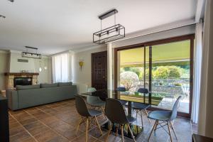 a living room with a table and chairs at SARREN VILLA POOL by Urdaibai Rentals in Bermeo