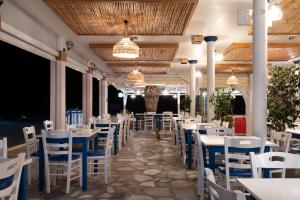 a row of tables and chairs in a restaurant at Prasonisi Light House Boutique Hotel in Prasonisi