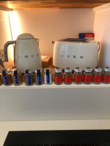 a counter with a toaster and jam jars on it at Le Plongeoir, intra-muros in Saint Malo