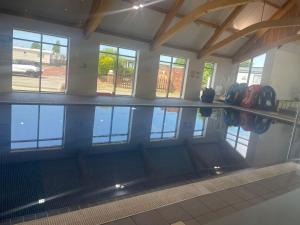 a swimming pool in a building with a reflection in the water at Shear water in Morecambe