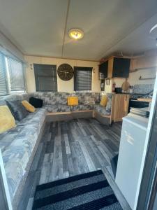 a living room with a couch and a kitchen at Shear water in Morecambe