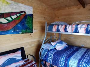 a room with two bunk beds and a painting at Cabaña Felipe Kaluf in Constitución
