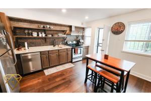 a kitchen with a wooden table and a wooden floor at Executive luxury for work or play in DC! in Washington, D.C.