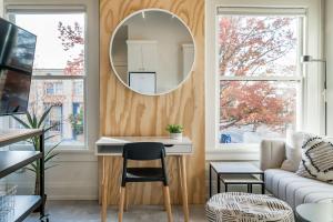 a living room with a table and a mirror at The 505 Eugene in Eugene