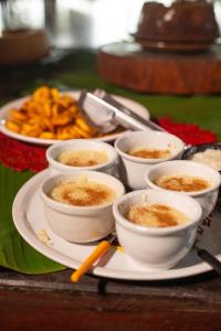 a plate with bowls of food on a table at Indaiá Eco Village in Ilhéus