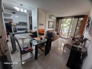 a large living room with a table and a couch at Reservas del peñon in Girardot