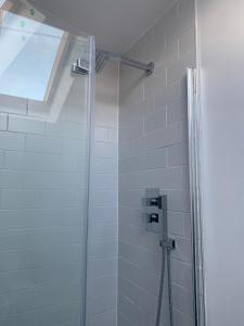 a shower with a glass door in a bathroom at The Bs Cycle, 4 Bedroom, 2 Bathroom, House in Harrogate Centre in Harrogate