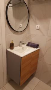 a bathroom with a sink and a mirror on the wall at Luxury apartments in DOWNTOWN of Perea in Perea