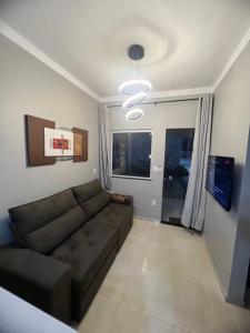 a living room with a brown couch in a room at Nos Lençóis Dunas Residence 9 in Santo Amaro